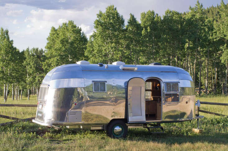 If only all campers were this pretty. After selling their four-bedroom house in Florida in 2013, Carmella and clan moved to a rental in Wyoming and then spent seven months in a camper while their cabin was being built. “Camper living gave us a sense of how small we could go and still be comfortable,” she says. “There’s something profound about being set in a place that forces you to define so carefully who you are and what you actually need to fully live.” Photograph of a restored 1954 Airstream Flying Cloud Travel Trailer via HomeDSGN.