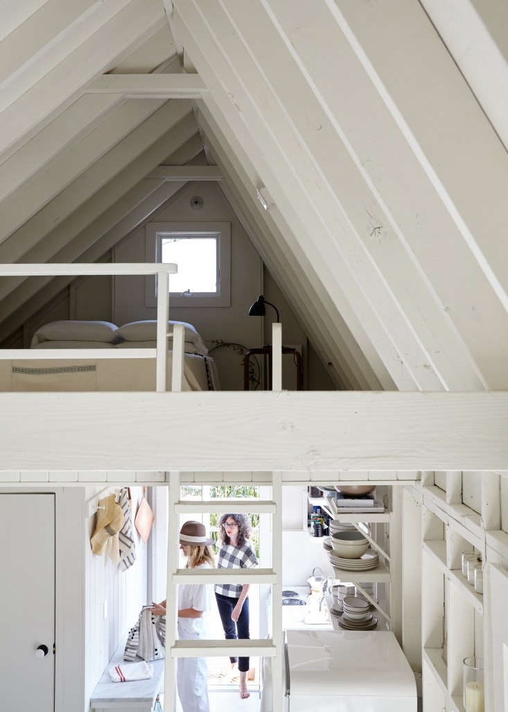 We love the artful look of the accidental shelving created by exposed framing (at right) in this tiny beach shack. Photograph by Kate Sears, from A Chic Fixer-Upper on Fire Island, Budget Edition.