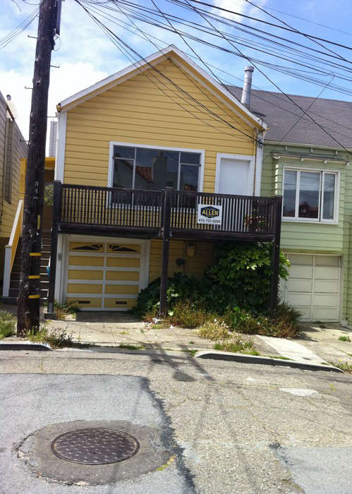 The original house (shown left, in yellow) had a garage on the ground floor and one-bedroom living quarters upstairs. 