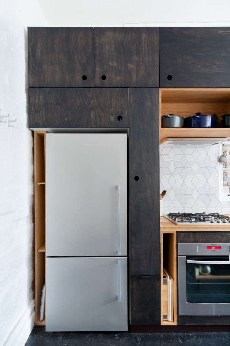 Most people would think the sliver of space between the refrigerator and the wall would be unusable, but in Trotter’s hands, it becomes storage slots for cutting boards and oven pans.