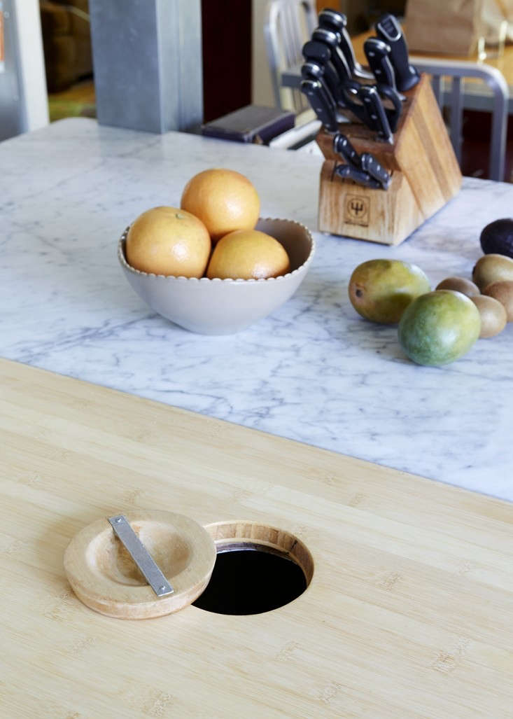 Authors Michael Chabon and Ayelet Waldman’s kitchen island is half Carrara marble, half bamboo. Chabon designed the inset circular cutout for easy composting. Photograph by Aya Brackett for Remodelista, from The Mysteries of Berkeley: A Literary Couple at Home.