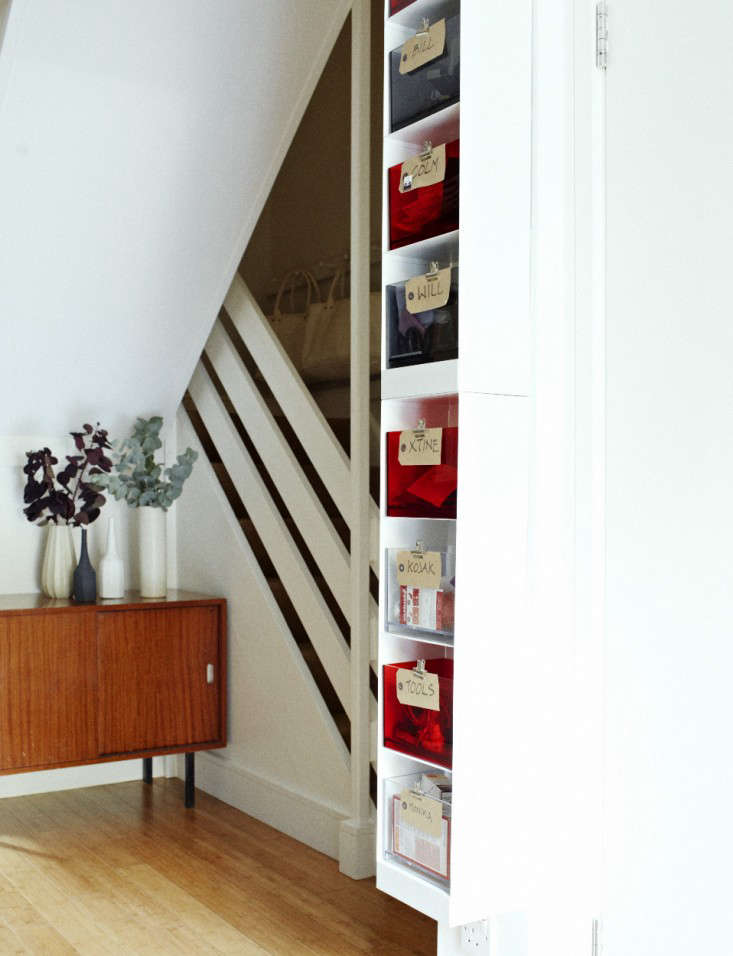 My husband earmarked a sliver of the wall in the entry hall for keys, transit cards, headphones, and other miscellaneous small items that are so easy to misplace and yet so important. He went to Habitat and devised a solution from what was there (he’s annoyingly good at this)–he combined white metal DVD shelves with acrylic storage boxes (both are no longer available at the store).