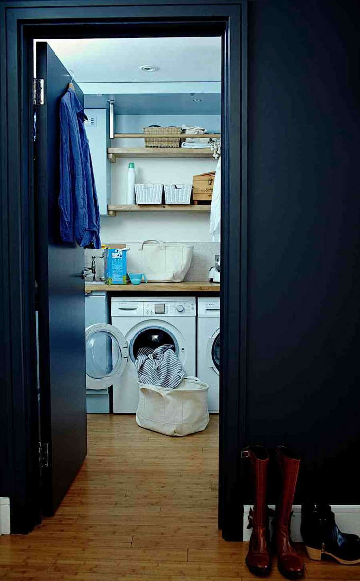  The cabinet doors open up to reveal the laundry area, complete with washer, dryer, and sink—an adapted version of my fantasy laundry room. See more small laundry rooms in 9 Favorite Laundry Rooms with Storage Ideas to Steal.