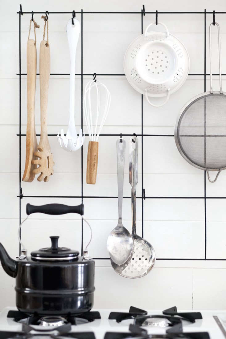 To keep a clean look, Mandi still stores the majority of her utensils in a drawer but says she loves having the most used items on hand. See more photos of the project in A Beautiful Mess.