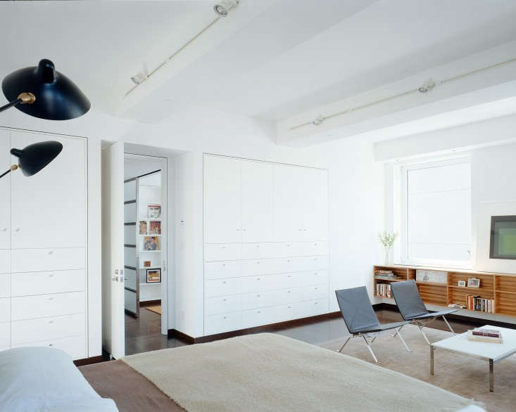 “The owners are minimalists, but they had large storage requirements,” says Jeff Sherman, of Delson or Sherman Architects. “Thickening the walls and recessing the cabinets flush with the walls allows a great deal of cabinetry to recede almost to the point of invisibility.” Photograph by Catherine Tighe, from The Architect Is In: Seeking Sunlight in Chelsea.