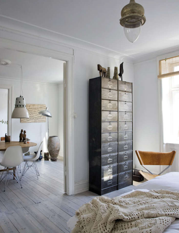 Metal cabinets in the bedroom of Danish designer Birgitte Rabens are used as a dresser. Photograph by Raul Candales for Elle Decor Spain.