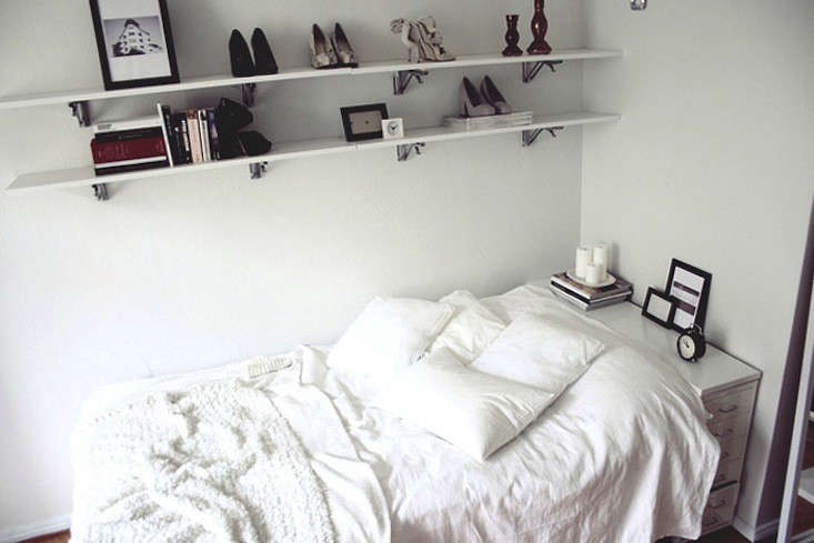 In a small bedroom, a white filing cabinet works as a headboard/bedside table. Photograph via Hananaa.