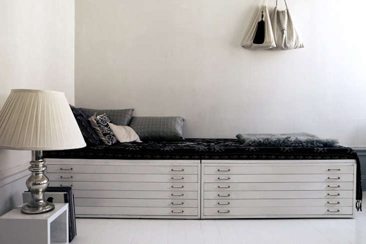 Stockholm shop owner and stylist Lotta Agaton created a daybed from a pair of flat files. Photograph by Pia Ulin for Lotta Agaton; seen on Emma’s Design Blogg.