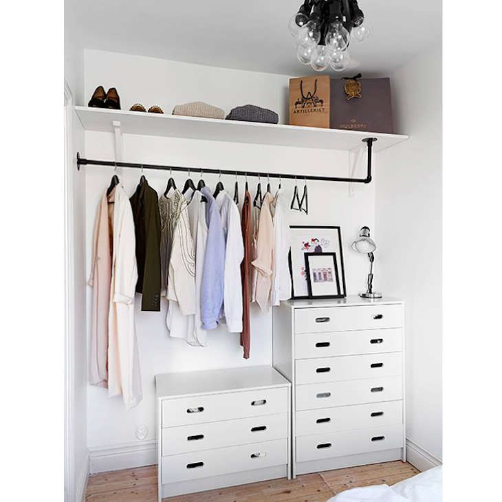 In need of a custom-shaped clothing rod? A DIY version fashioned from black plumbing pipe does the trick in Steal This Look: A Well-Organized Closet on a Budget.