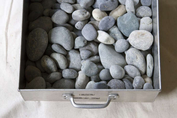 Next, I filled the box with a thin layer of smooth beach stones. You can purchase these from your local hardware or landscaping store, or collect them over time on beach adventures. Be mindful that stones can get heavy, so make sure to keep your layer of stones thin enough so that they don’t bend the box.