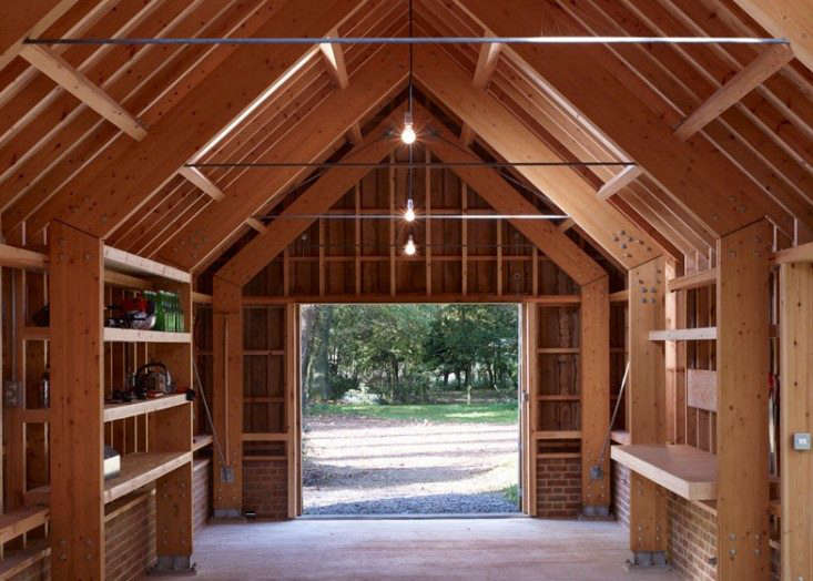  Shelves, storage, and waist-high work stations are built into the walls of this multi-use studio. Photograph via Cassion Castle Architects, from Outbuilding of the Week: Designer Tim Lloyd’s Timber Work Studio in Hampshire.