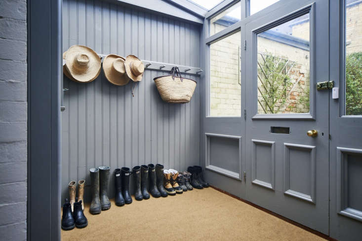 A row of Shaker pegs accommodates hats and bags in this classic English entryway. See On the Market: A Historical House Reimagined for a Modern Family in Stroud, England.