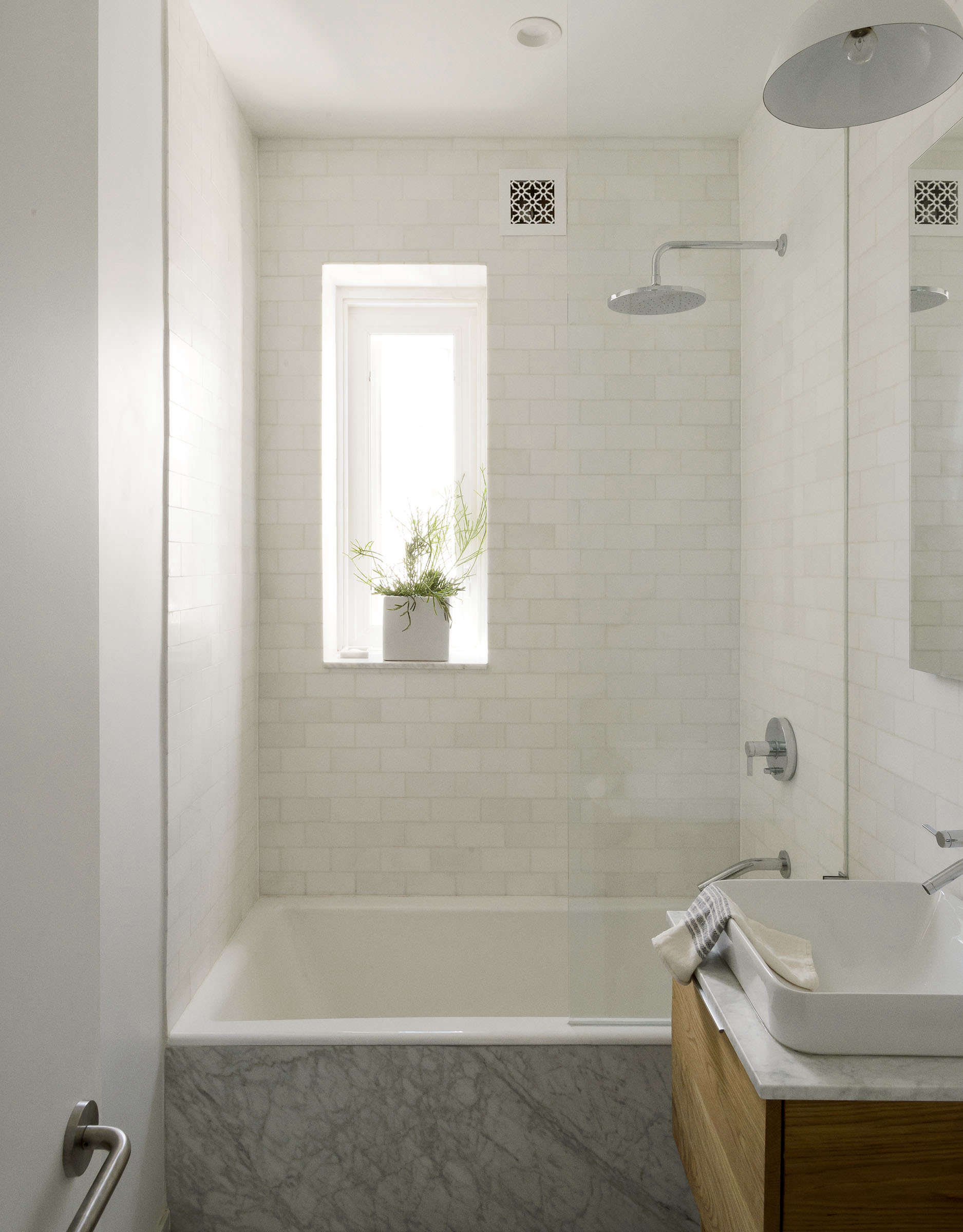 Compact marble tiled bath in Jacqueline-Schmidt and David Friedlander's 675-square-foot Brooklyn quarters, Matthew-Williams-photo | Remodelista