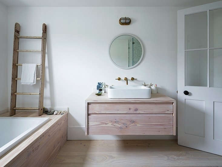 A vanity that has it both ways—ample storage and an airy feel. Photograph courtesy of Rory Gardiner, from Steal This Look: A London Bathroom Clad in Dinesen Wood.