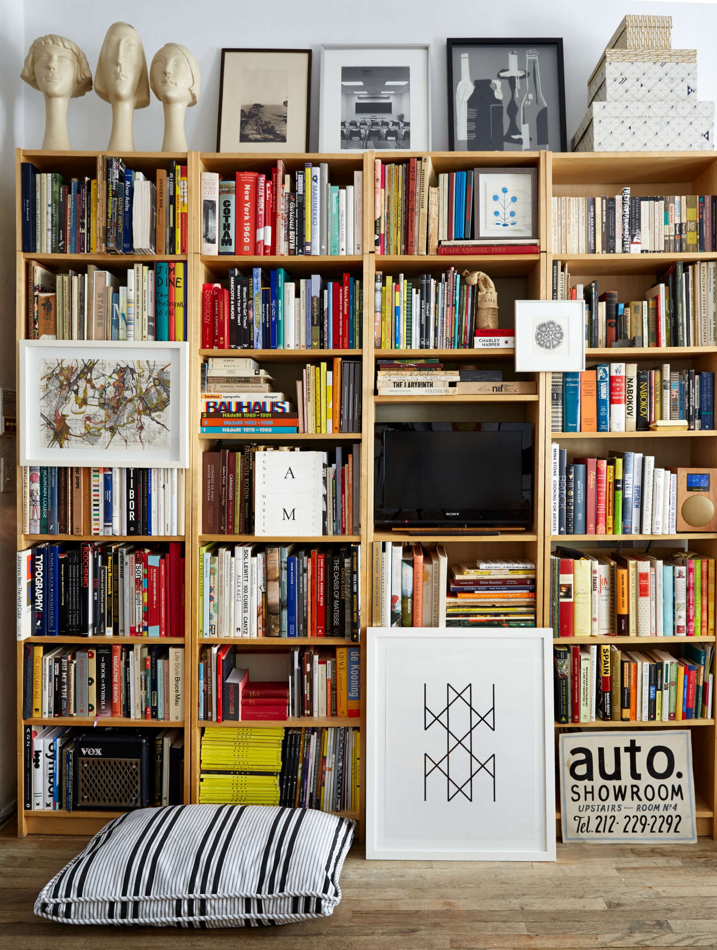 Four Billy Bookcases placed side by side, give the illusion of custom bookshelves; $59 each. Photograph by Kate Sears, from Small-Space Solutions: 17 Affordable Tips from an NYC Creative Couple.