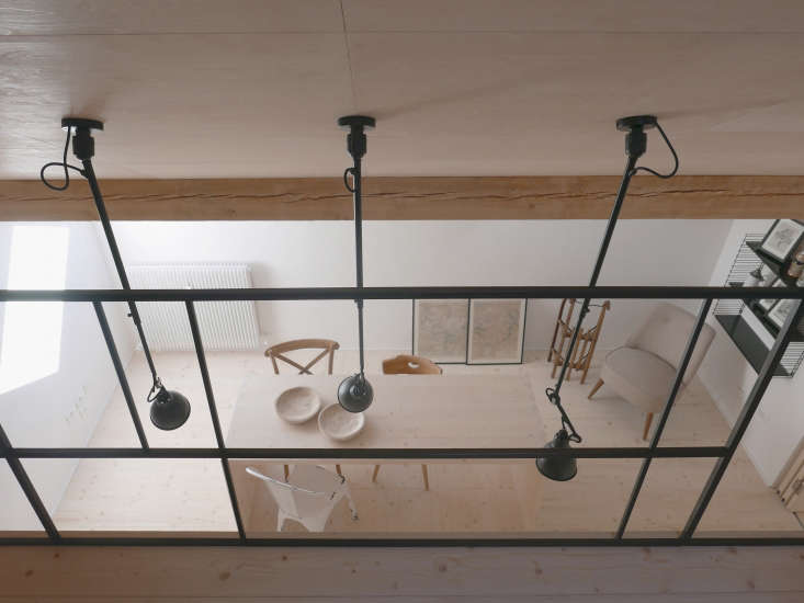 Jab used only three materials in the compact space—light wood, white  fixtures, plus black metal accents in the ceiling lights, railings, and bath fixtures.