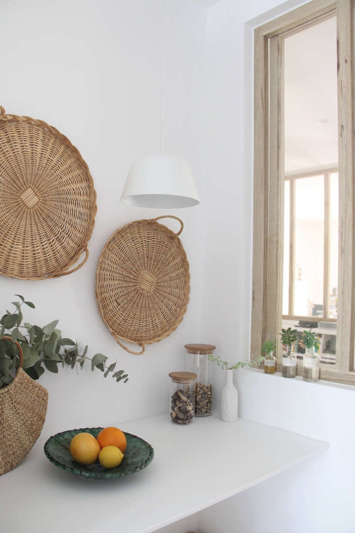 Italian pasta baskets decorate a kitchen wall in designer Ilaria Fatone's South of France Ikea hack kitchen 