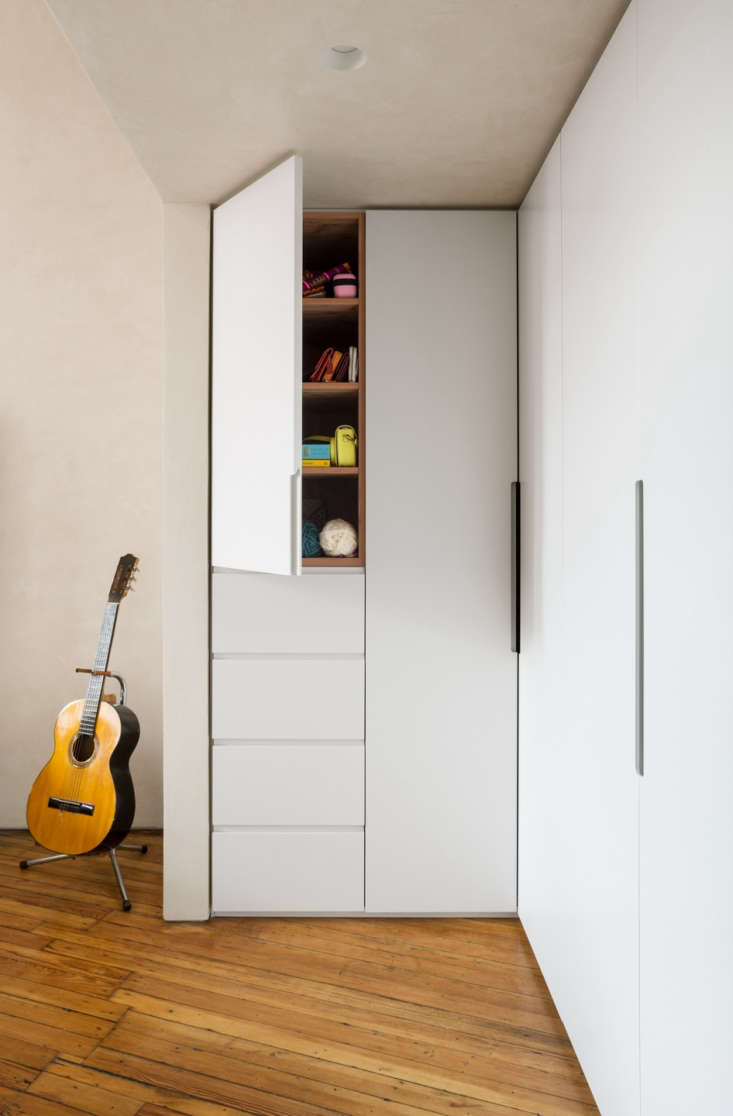 A trio of custom built-in closets are installed under a sleep loft. Photograph by Devon Banks, courtesy of Denise Lee Architect, from Before & After: A Gramercy Park Apartment Transformed.