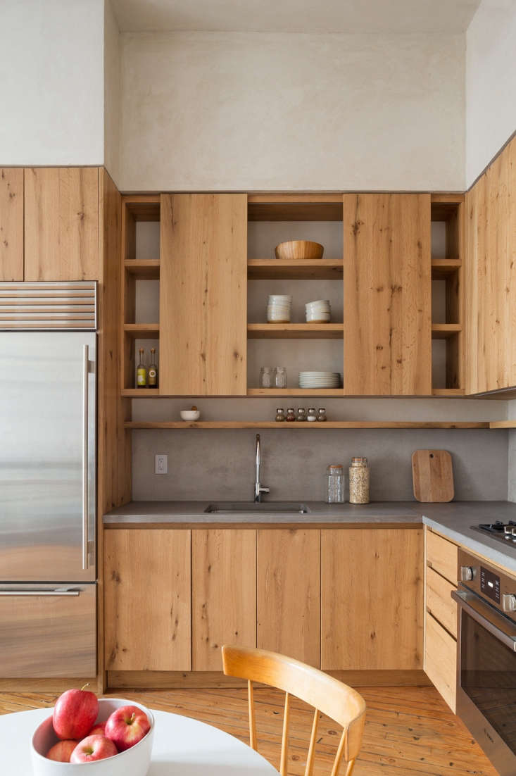 The kitchen countertops and backsplash are made of concrete, and the custom cabinetry is reclaimed white oak. Lee chose the combination for its organic modern look.