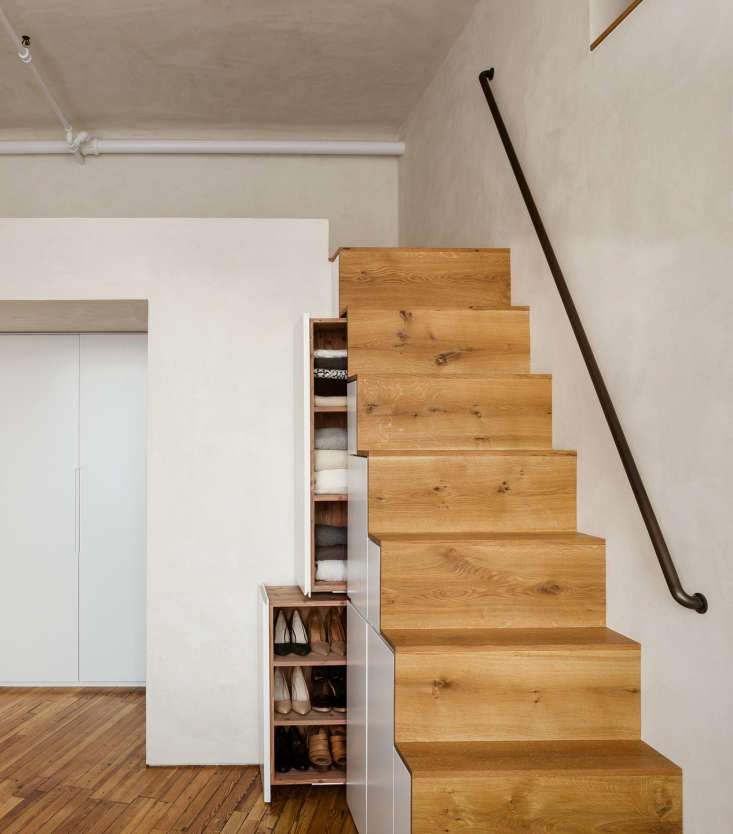 Under-the-staircase laminate-faced cedar drawers store clothes, shoes, and accessories.