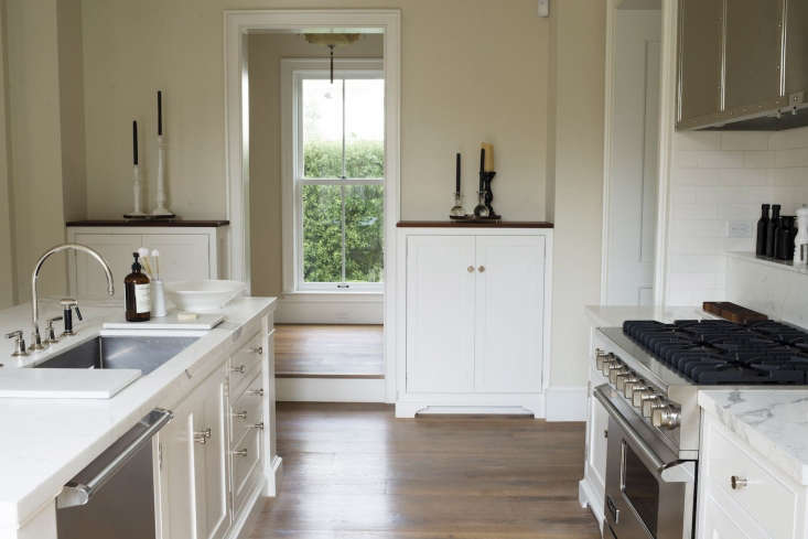 A side view of the kitchen shows two built-in, chest-height cabinets flanking a staircase landing. “It’s an alternate kitchen cabinet solution,” Barbara says. “It means you don’t need cabinets overhead.”