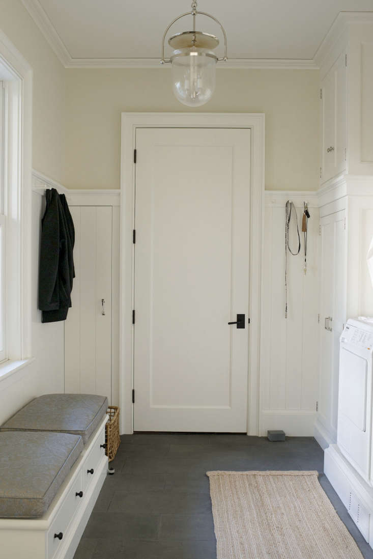 Mirroring the pantry, on the other side of the kitchen, is a mudroom entrance with laundry. The pendant light is from Urban Electric.