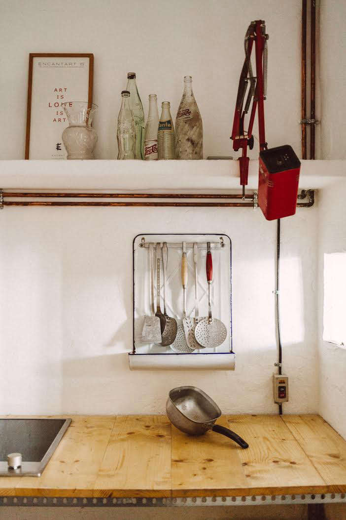 French enamelware utensil rack in Quintana Partners' Sa Calma annex kitchenette, Menorca, Spain