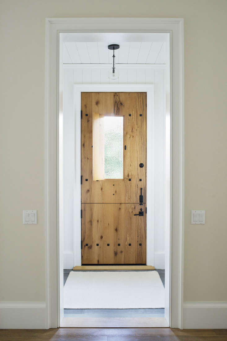 The front door is a distressed oak Dutch door with an inset cutout window. On warm days, Barbara leaves the top half wide open. “It’s really beautiful to sit in the dining room and look straight outside.”