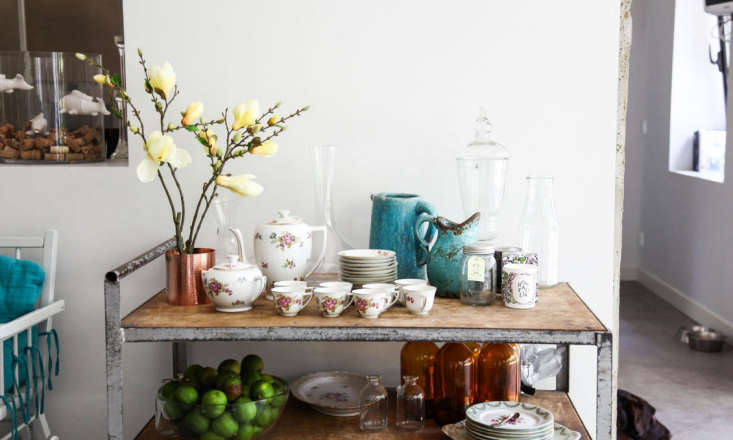 An industrial cart used as a side table in interior designer Clarisse Prudent's Burgundy dining room. Photograph via The Socialite Family.