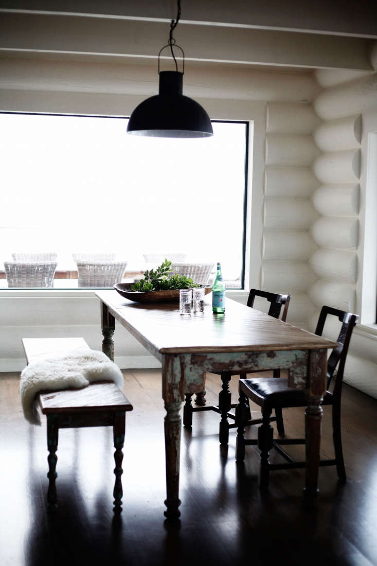 Antique farmhouse dining table in a whitewashed cabin kitchen on San Juan Island, Lisa Staton Design.