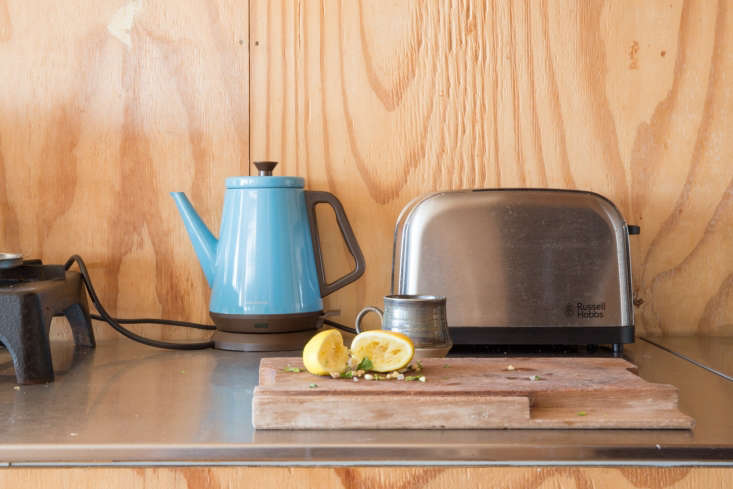 Plywood kitchen counter still-life with Japanese blue electric kettle. Marcia Miihotich photo.