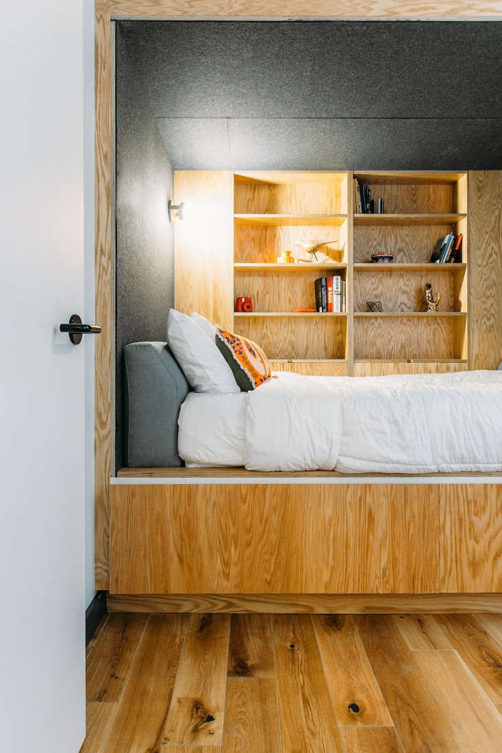 Plywood bedroom with built-in shelves in WeLive Wall Street