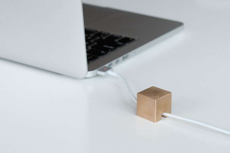 Made by a small San Francisco design firm, Stacks is a 2.5cm metal cube with a small passageway for a single cord to run beneath. The “impossibly heavy” holder stays put on the desk, and can be stacked and paired to hold multiple cables. Available in brass (shown) or steel; $10 each.