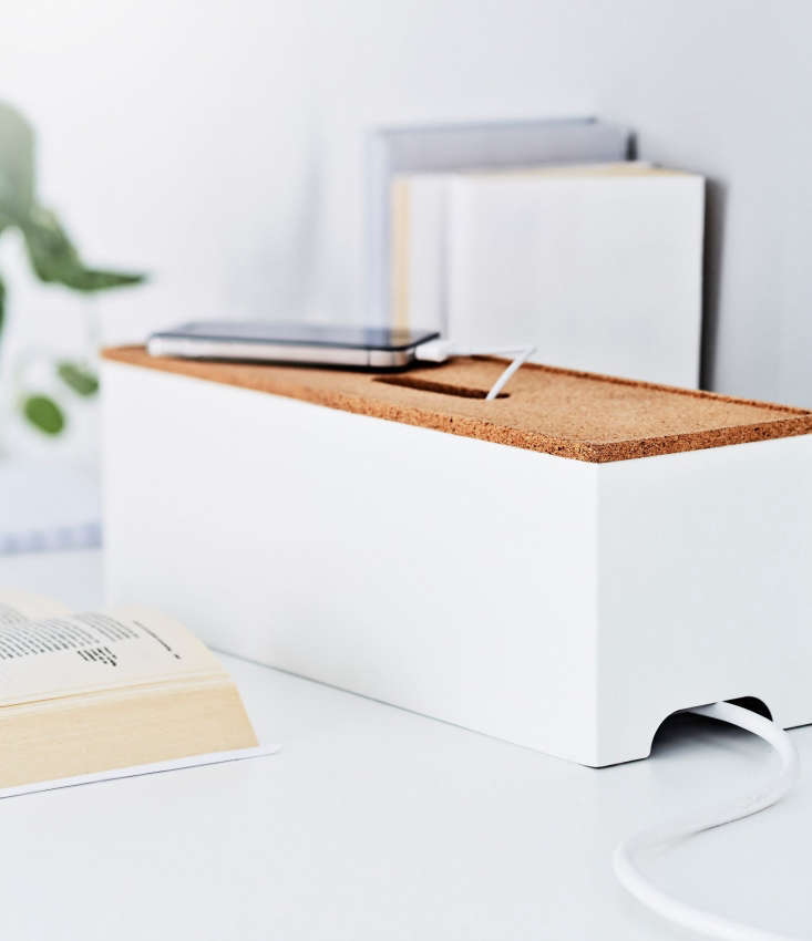 Ikea’s Kvissle cable management box is made of white powder-coated steel with a cork lid, through which your gadgets can access their charging cords; $9.99.