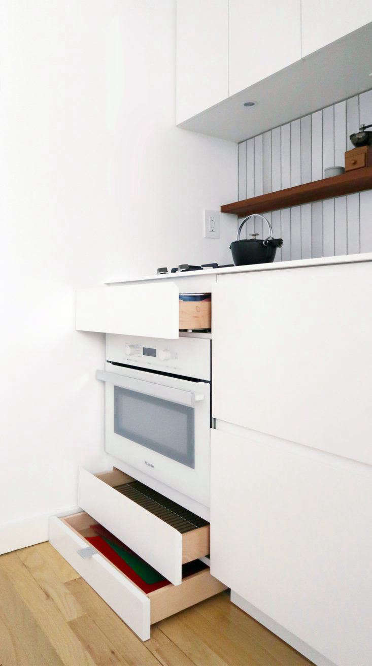 A small Miele speed oven—a combination microwave and convection oven—leaves room for drawers both above and below.