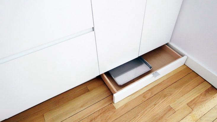 The cabinet toe kicks are drawers for storing shallow items like pans, cutting boards, and baking racks.