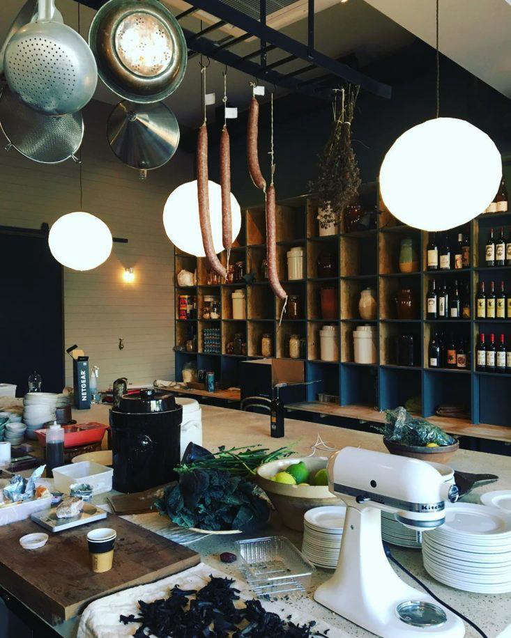 This huge kitchen island serves as both a work surface for staff and, on the other side, an eat-in counter for customers.