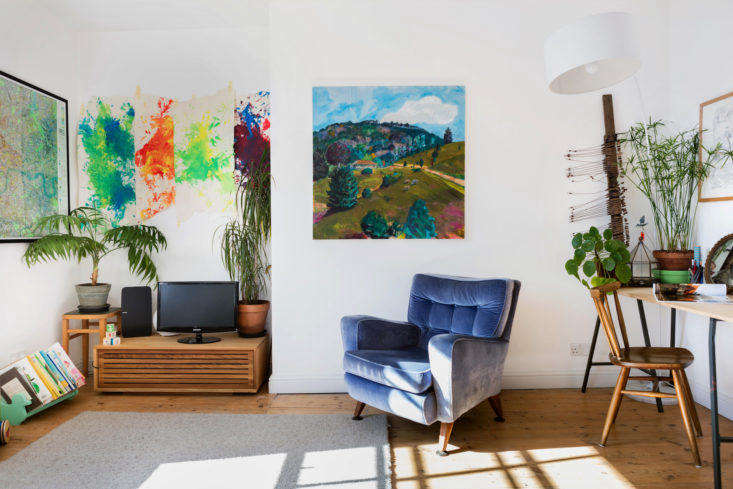 Kids artwork, blue chair, oil painting in remodeled small London apartment 