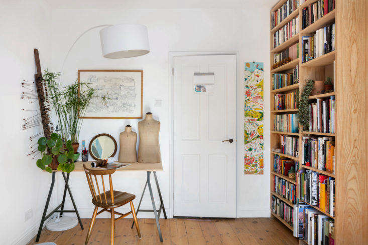 Front door in a small space London apartment with desk and bookshelf