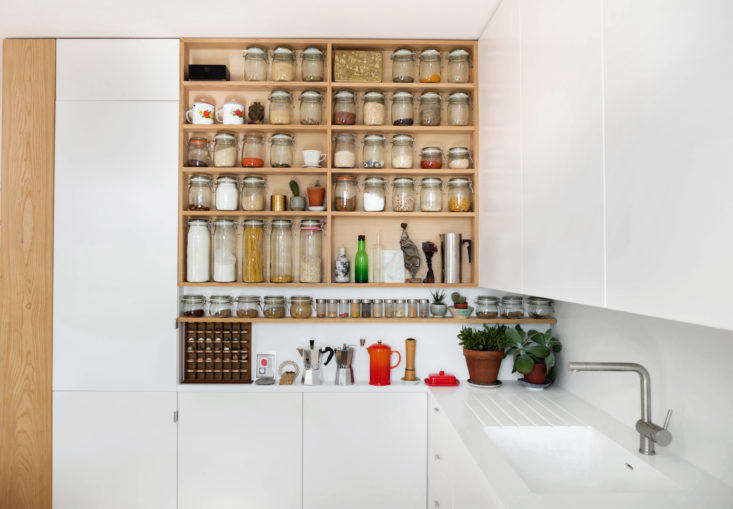 In addition to the open pantry that was DIY’d by the homeowners using ash wood, they managed to fit two Ikea wall cabinets on top of each other to the left of it, and turn the leftover space above into a cabinet of its own. See Tricks of the Trade: 7 Small-Space Storage Tips from Emil Eve Architects. Photograph by Mariell Lind Hansen, courtesy of Emil Eve.