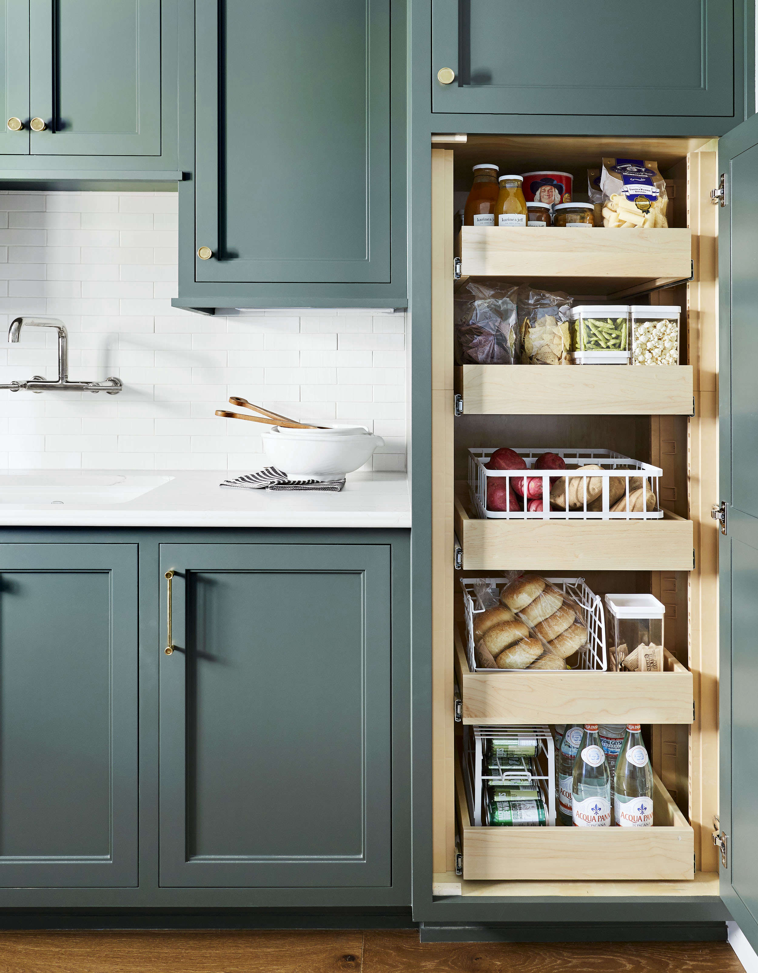 Designer Emily Henderson utilizes Target’s line of organizers—from stackable food containers to metal baskets and bins—to keep this pantry looking tidy. A can dispenser on the bottom shelf ensures that the oldest cans get consumed before the newer ones. Photograph by Sara Tramp, from A Place for Everything: Thoughtful Storage in Emily Henderson’ Portland Project.