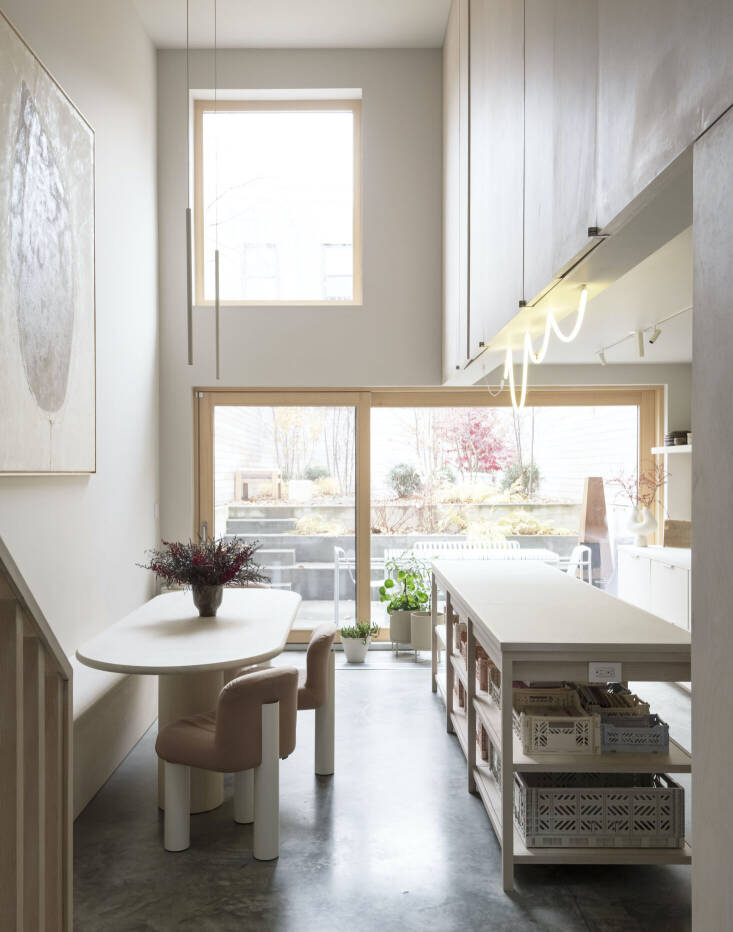 The soft pastel colors of the baskets add a touch of whimsy to the polished concrete kitchen floors without being overwhelming.