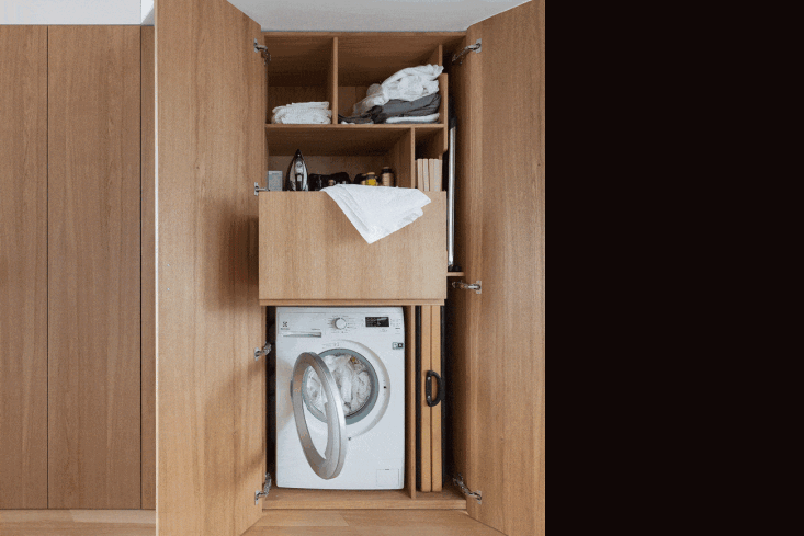 In a tiny, 355-square-foot apartment designed by firm Studio Bazi, the kitchen and laundry rooms hide behind oak wood accordion doors. When opened, they reveal, among other things, a pull-out garbage bin. Read more in The Secret Apartment: A Hyperefficient Moscow Flat with Stealth Storage (and a Hidden Kitchen). Photograph by Polina Poludkina.